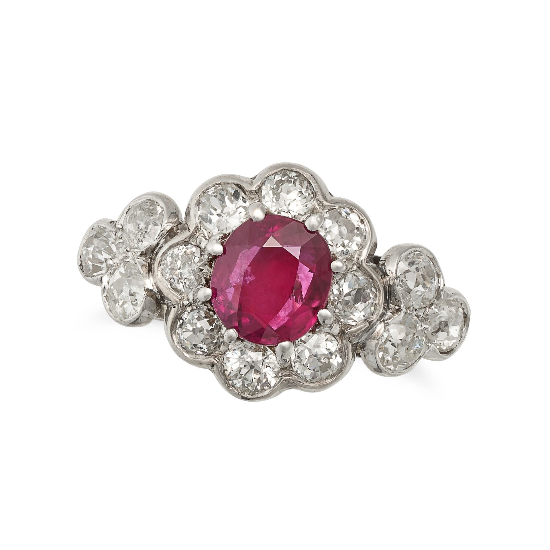 A RUBY AND DIAMOND CLUSTER RING in white gold, set with a cushion cut ruby of approximately 1.04 ...
