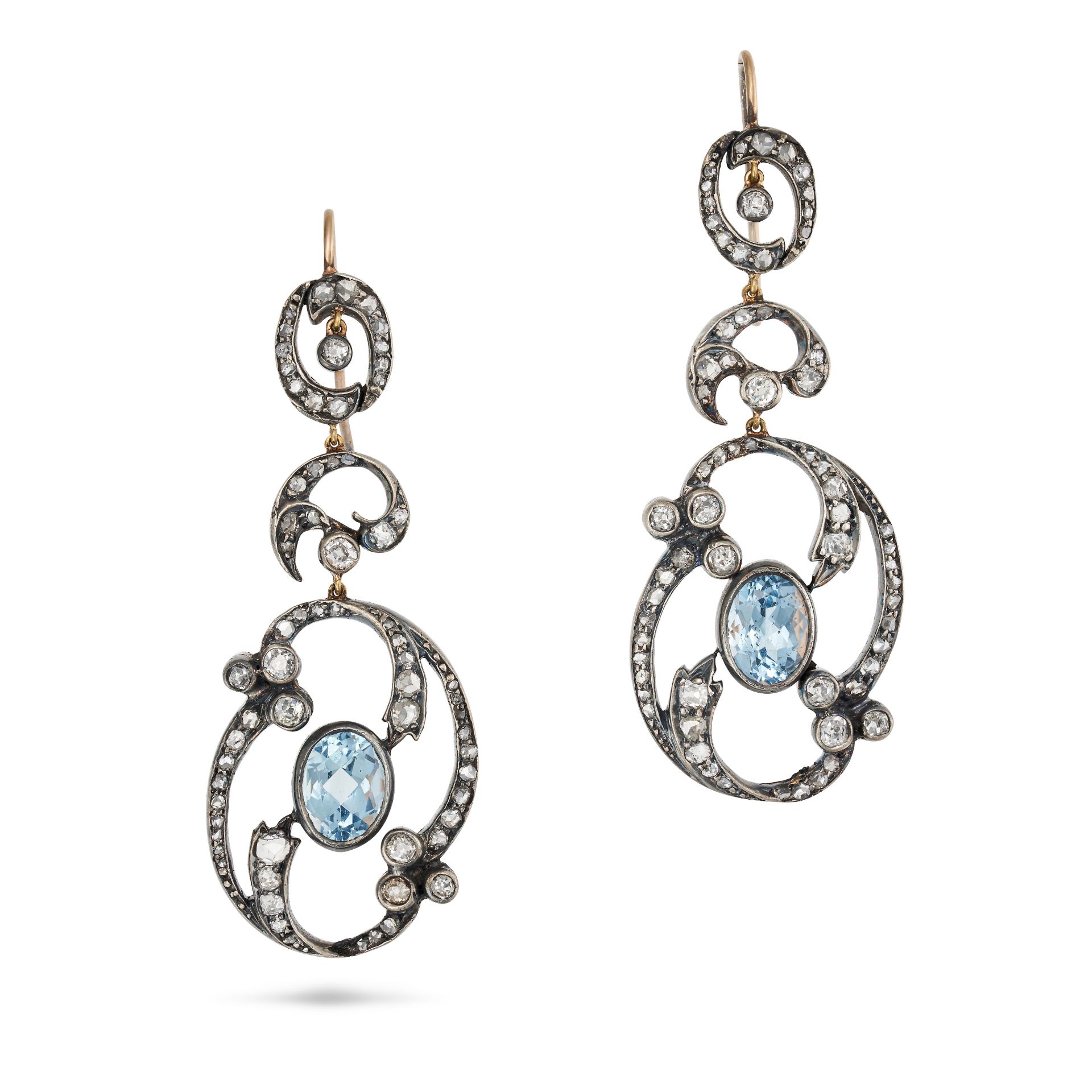 A PAIR OF AQUAMARINE AND DIAMOND DROP EARRINGS in yellow gold and silver, the scrolling openwork ...