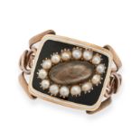 AN ANTIQUE GEORGIAN ENAMEL AND PEARL MOURNING RING in yellow gold, comprising hairwork beneath a ...