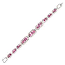 A BURMESE RUBY AND DIAMOND BRACELET in 14ct white gold, comprising a row of oval links set with o...