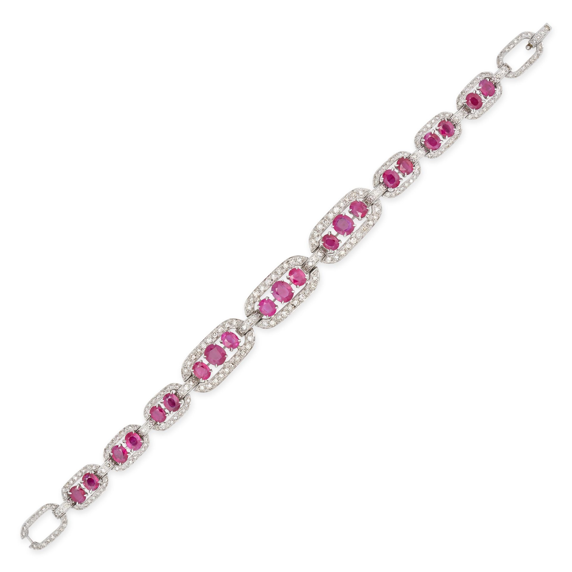 A BURMESE RUBY AND DIAMOND BRACELET in 14ct white gold, comprising a row of oval links set with o...