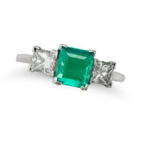 AN EMERALD AND DIAMOND THREE STONE RING in platinum, set with an octagonal step cut emerald of ap...