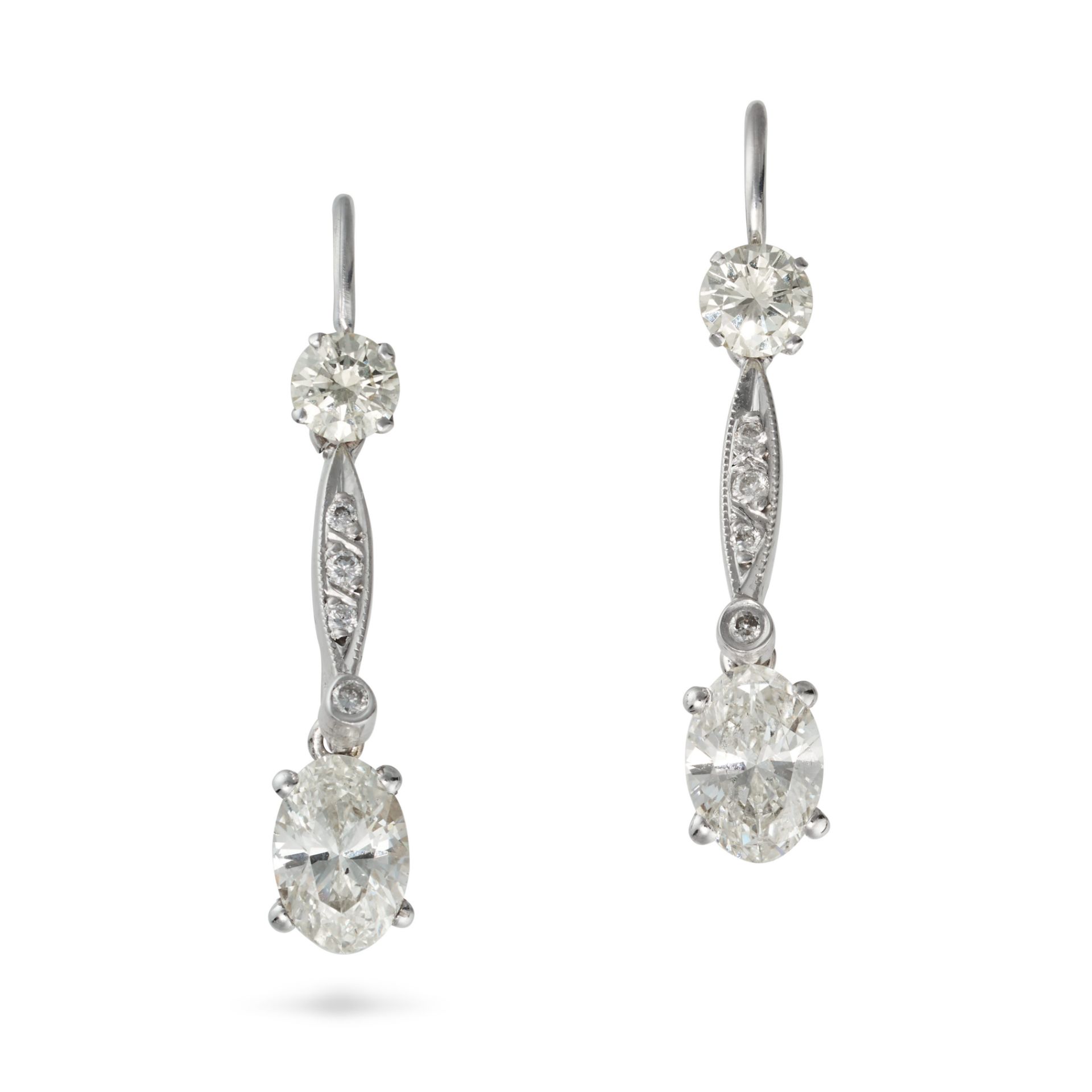 A PAIR OF DIAMOND DROP EARRINGS in white gold, each set with a round brilliant cut diamond suspen...