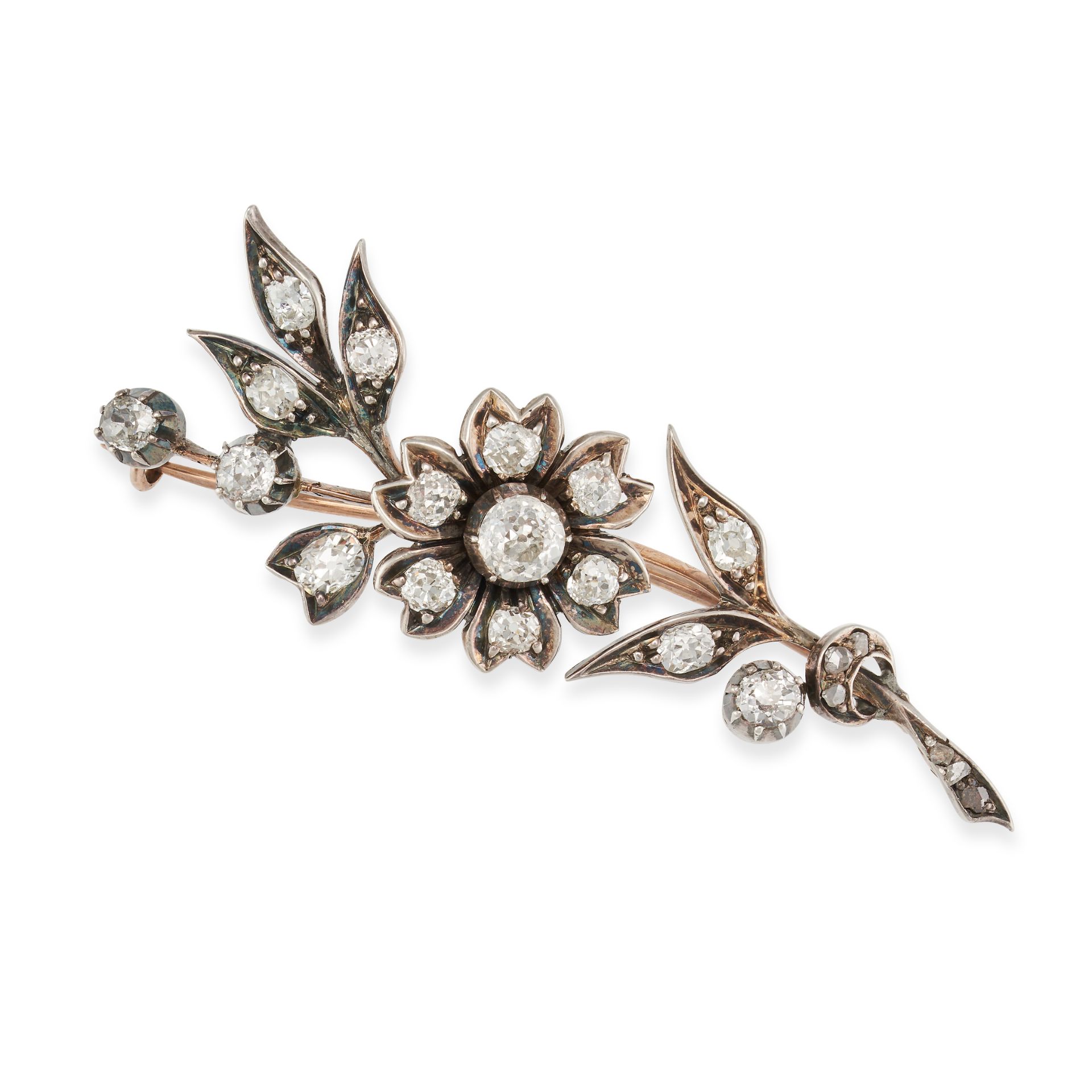 AN ANTIQUE DIAMOND FLOWER BROOCH in yellow gold and silver, designed as a floral spray set throug...