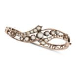 AN ANTIQUE DIAMOND BANGLE in yellow gold, the hinged bangle in foliate design set with rose cut d...