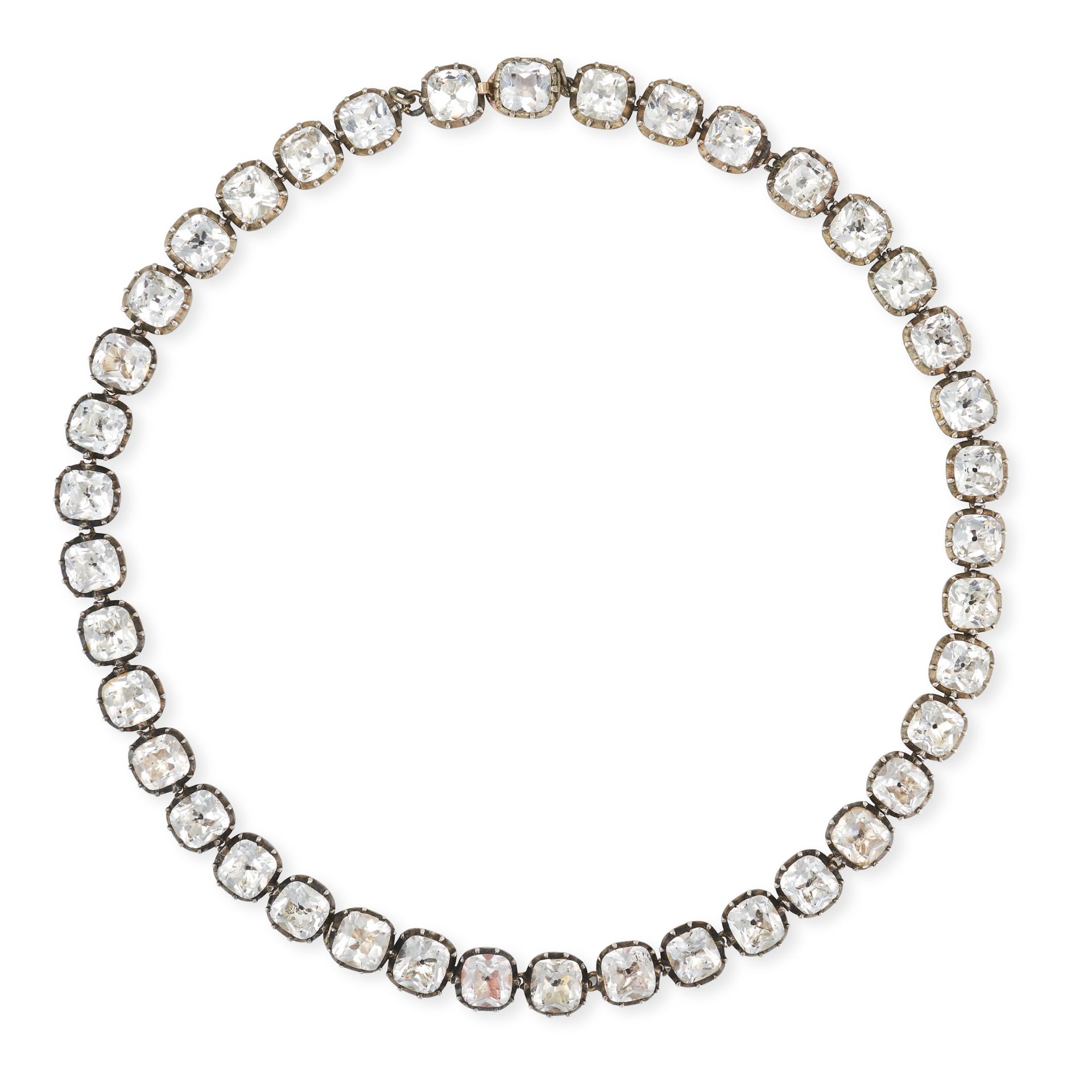 AN ANTIQUE BLACK DOT PASTE RIVIERE NECKLACE in silver, comprising a single row of cushion cut bla...