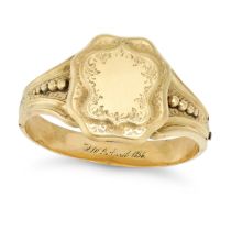 AN ANTIQUE MOURNING BANGLE in yellow gold, the hinged bangle with a sheild shaped face, engraved ...