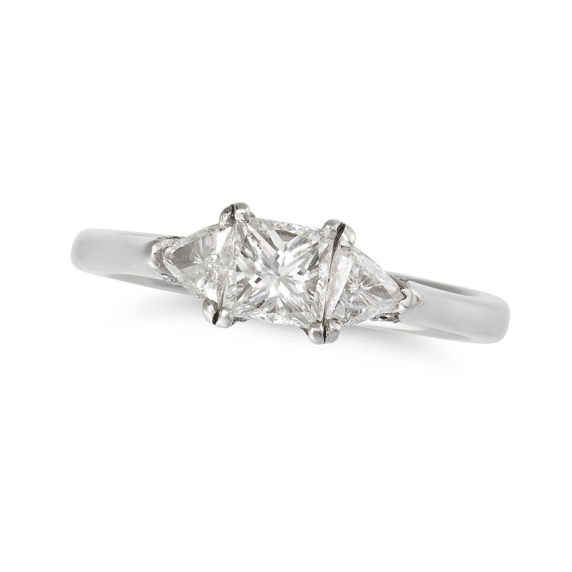 NO RESERVE - A THREE STONE DIAMOND RING in platinum, set with a princess cut diamond accented on ...