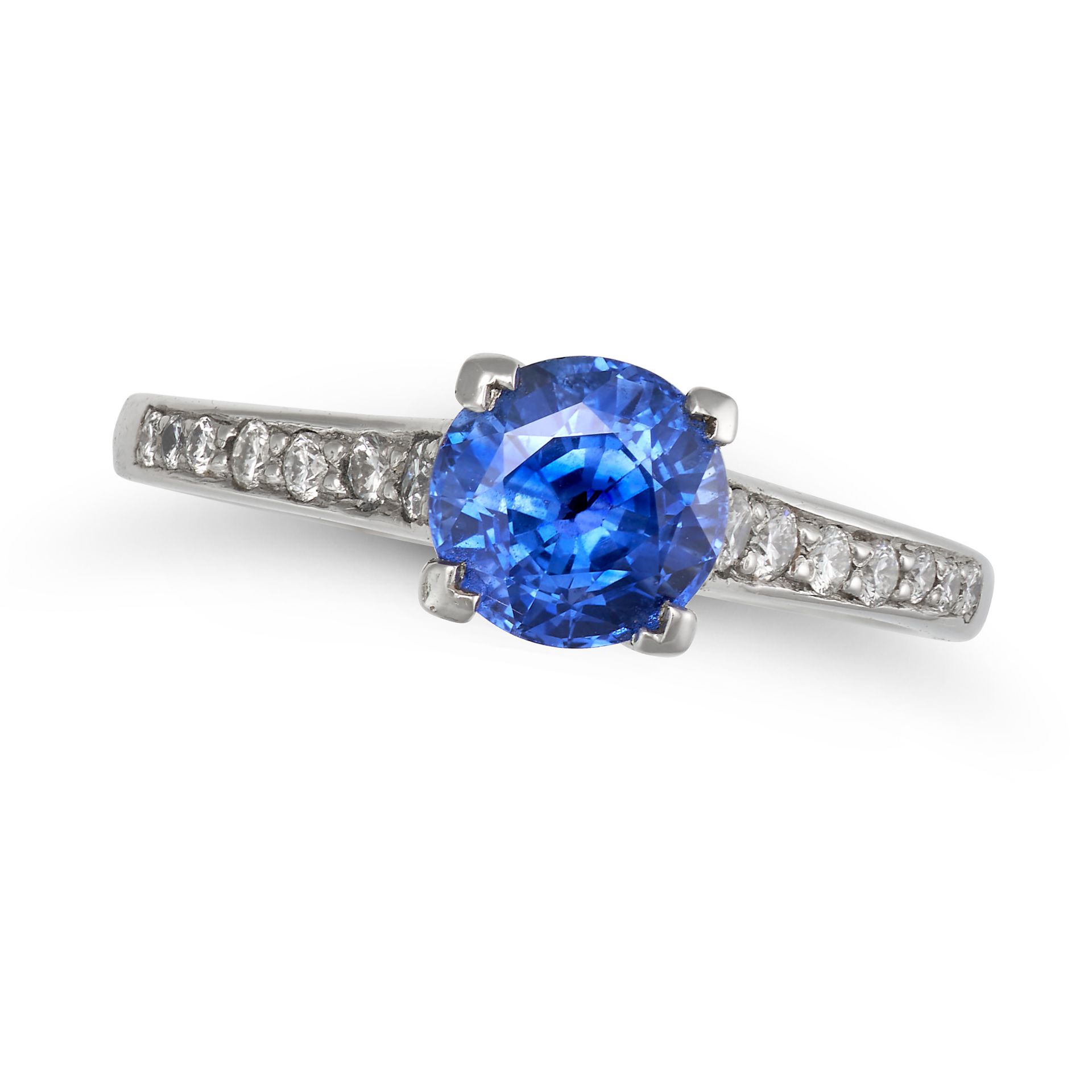 NO RESERVE - A SAPPHIRE AND DIAMOND RING in platinum, set with a round cut sapphire of 1.40 carat...