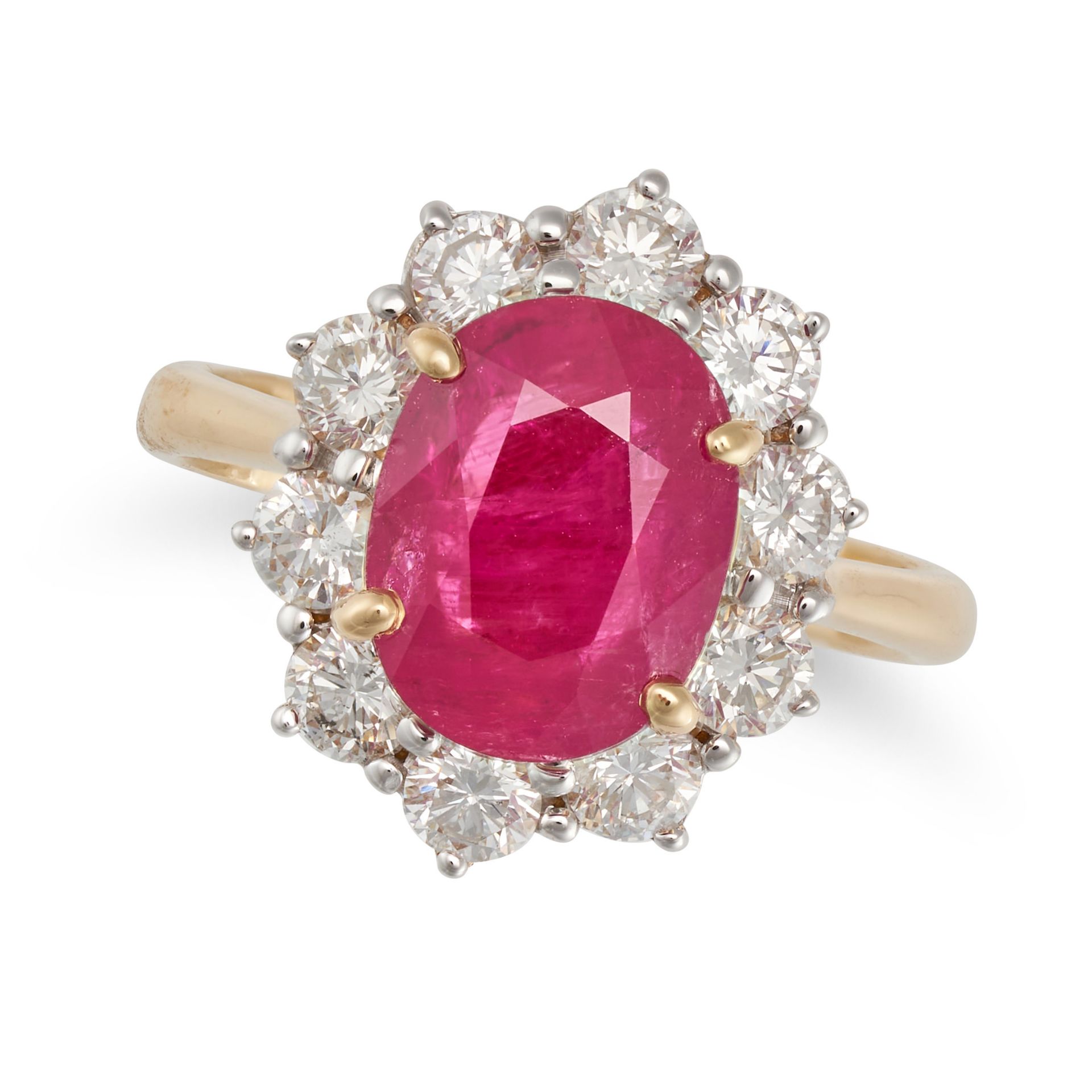 A RUBY AND DIAMOND CLUSTER RING in 18ct yellow gold, set with an oval cut ruby of 4.11 carats in ...