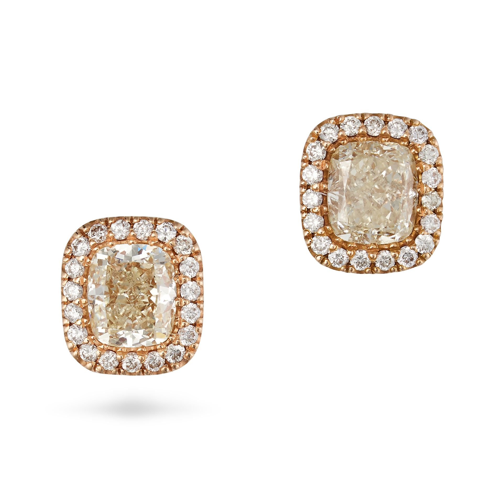 A PAIR OF DIAMOND STUD EARRINGS in 18ct yellow gold, each set with a cushion cut diamond of appro...