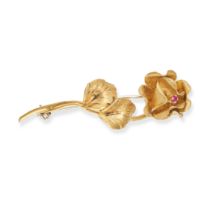 A RUBY ROSE BROOCH in 18ct yellow gold, designed as a rose, set to the centre with a round cut ru...