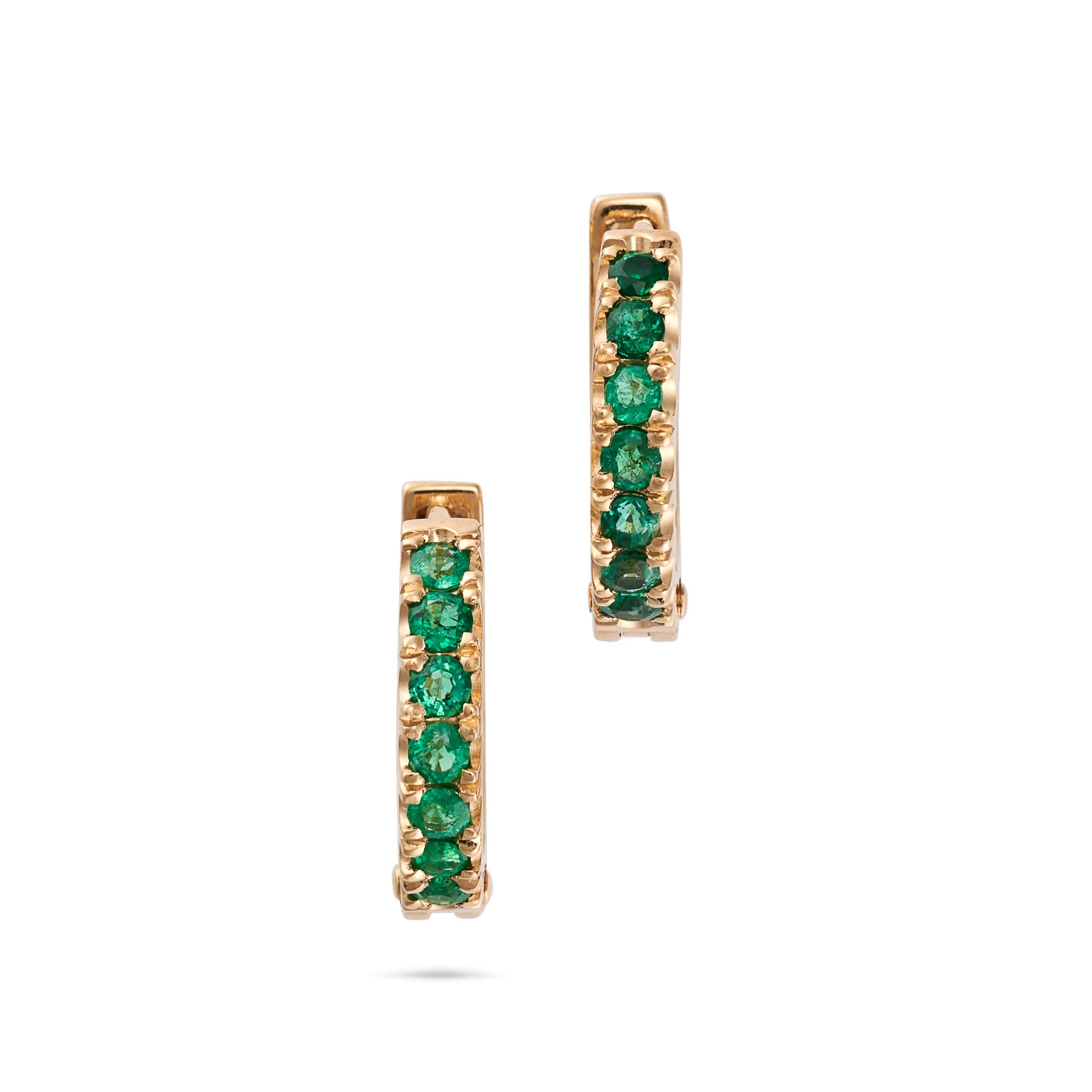 A PAIR OF EMERALD HUGGIE HOOP EARRINGS in 18ct yellow gold, each designed as a hoop set with a ro...