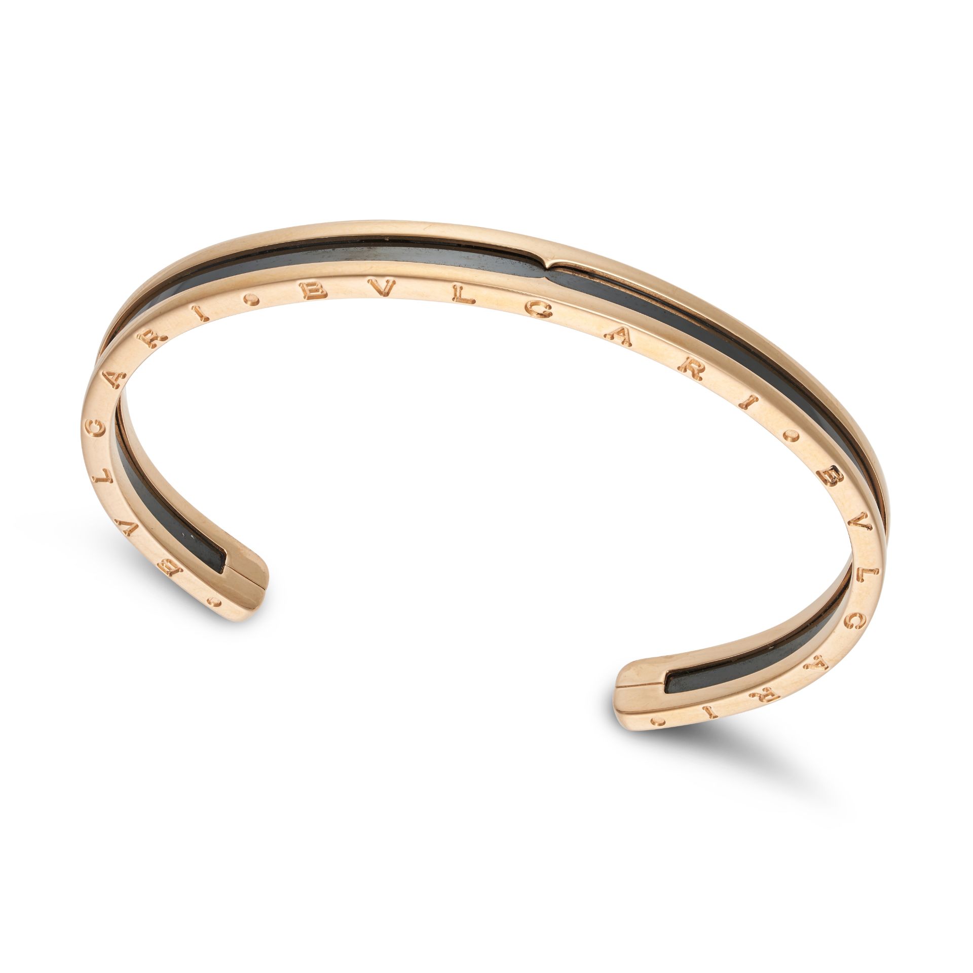 BULGARI, A B.ZERO BANGLE in 18ct rose gold and black steel, the open cuff set with black steel an...