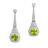A PAIR OF PERIDOT AND DIAMOND DROP EARRINGS in white gold, each comprising a row of round brillia...