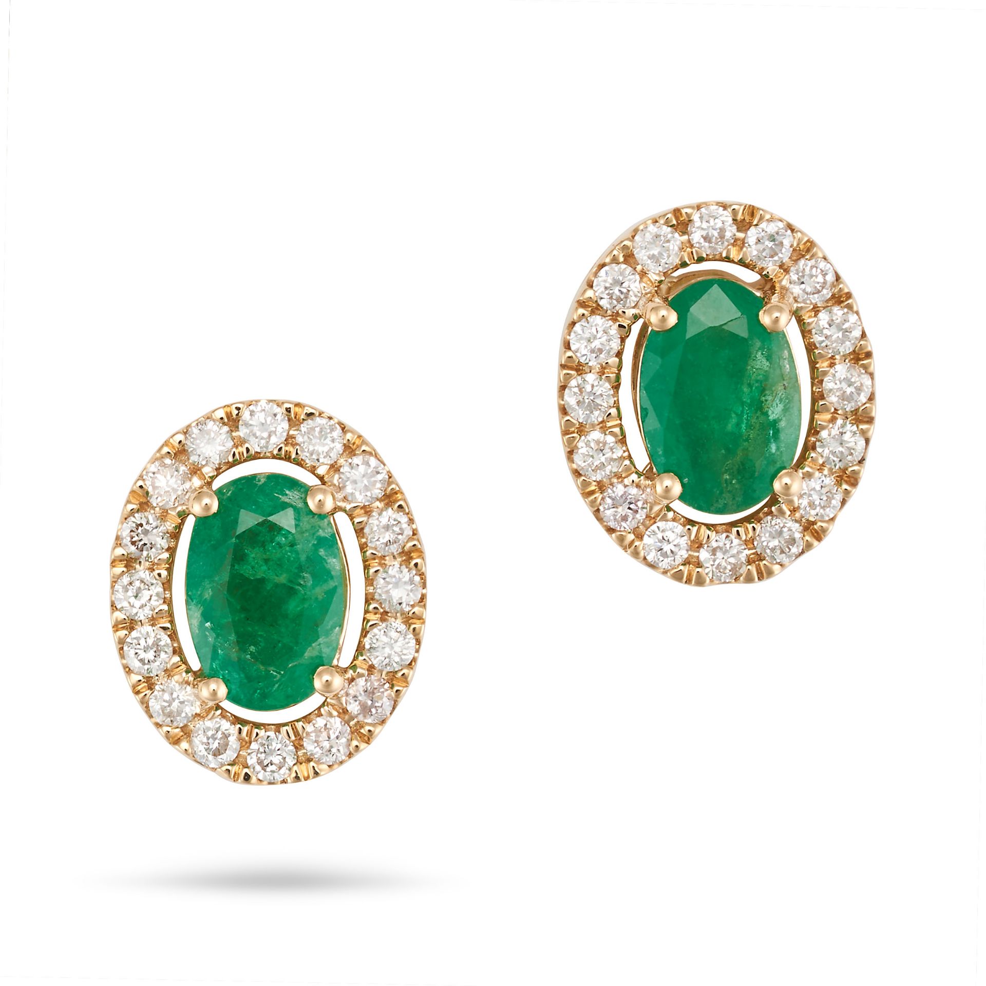 A PAIR OF EMERALD AND DIAMOND EARRINGS in 14ct yellow gold, each set with a central oval cut emer...