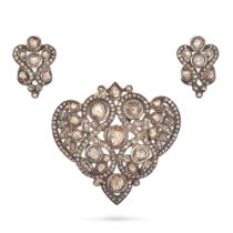 AN INDIAN DIAMOND PENDANT AND EARRINGS SUITE in silver, each in a scrolling foliate design and se...