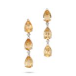 A PAIR OF YELLOW TOPAZ AND DIAMOND EARRINGS in 18ct white gold, each set with a row of pear cut y...