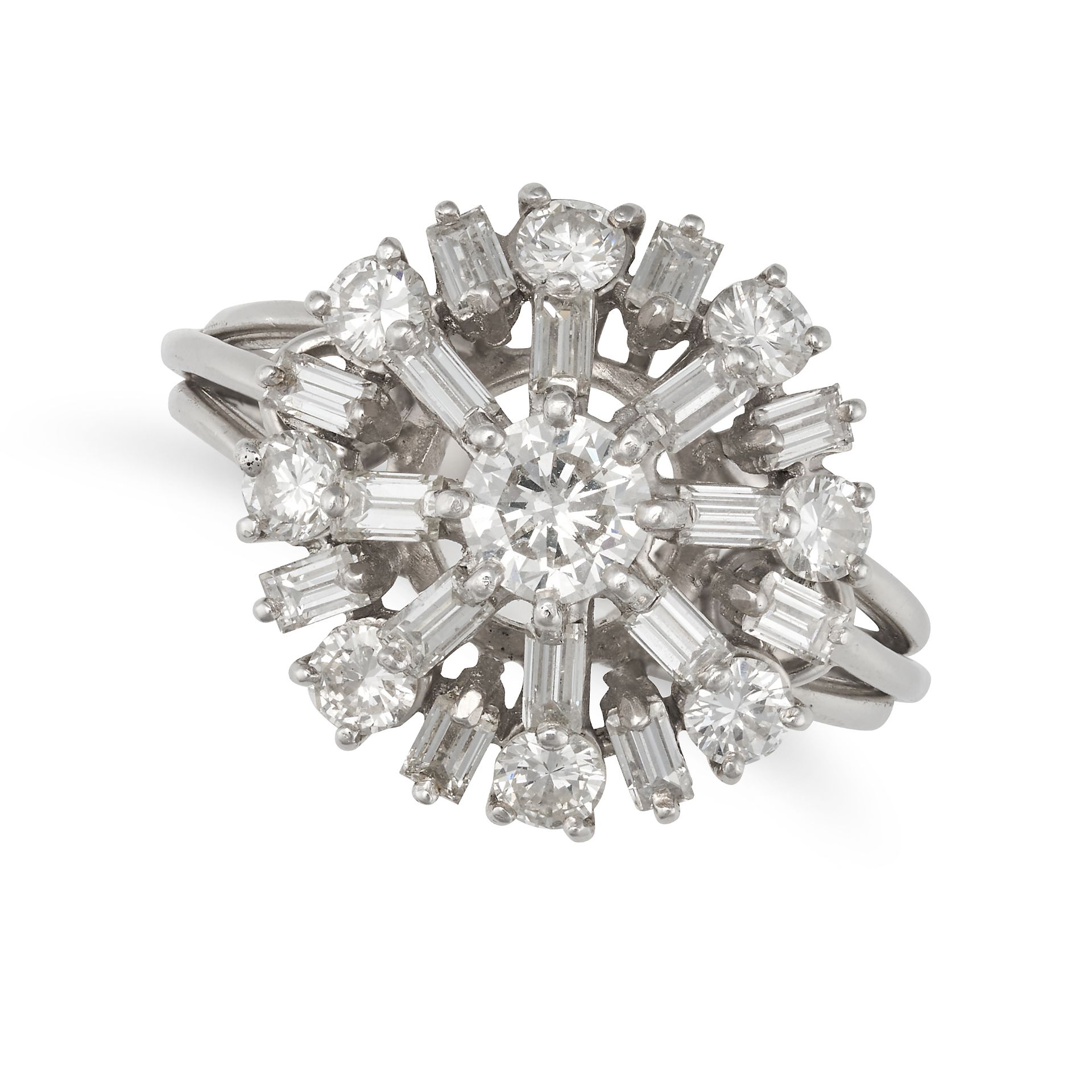 A DIAMOND CLUSTER RING in platinum, set with a round brilliant cut diamond in a cluster of baguet...