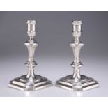 A PAIR OF GEORGE I CAST SILVER CANDLESTICKS