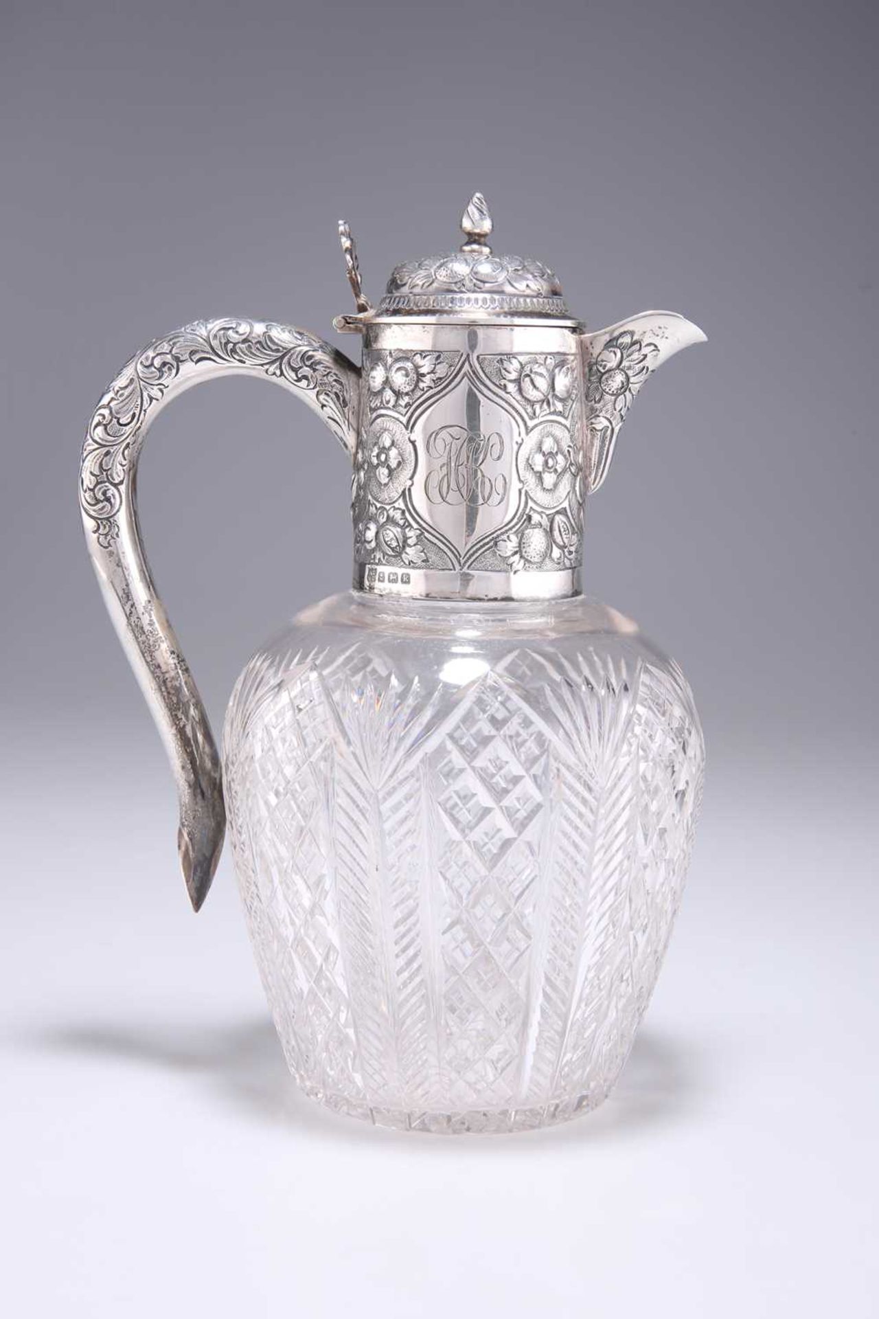 AN EDWARDIAN SILVER-MOUNTED CUT-GLASS CLARET JUG