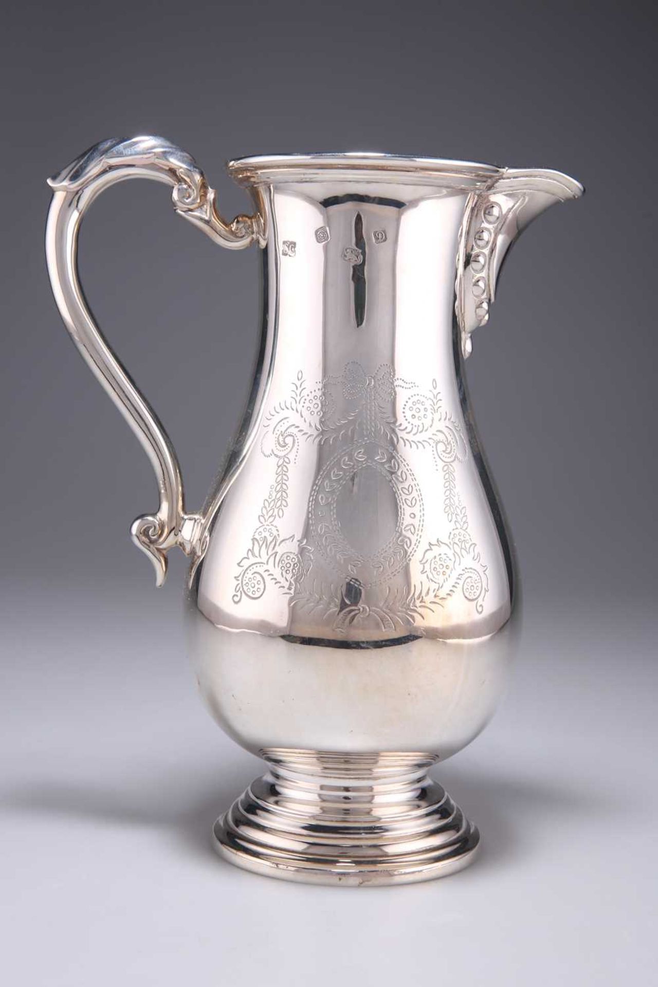 A GEORGIAN STYLE SILVER BEER JUG