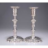 A PAIR OF GEORGE II CAST SILVER CANDLESTICKS