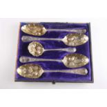 A SET OF FOUR GEORGIAN SILVER BERRY SPOONS AND A SIFTING LADLE