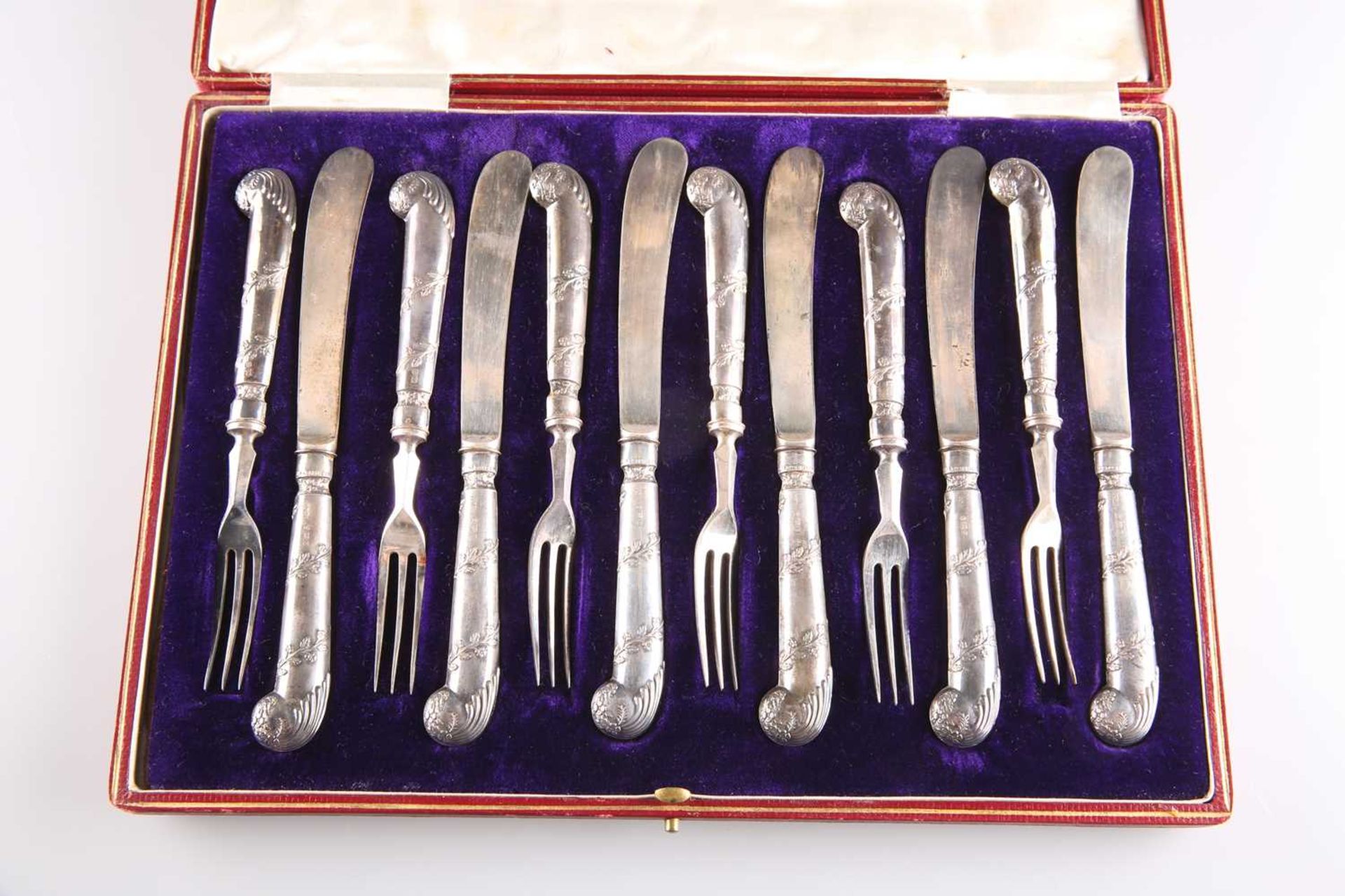 A SET OF SIX PAIRS OF EDWARDIAN SILVER-HANDLED DESSERT KNIVES AND FORKS