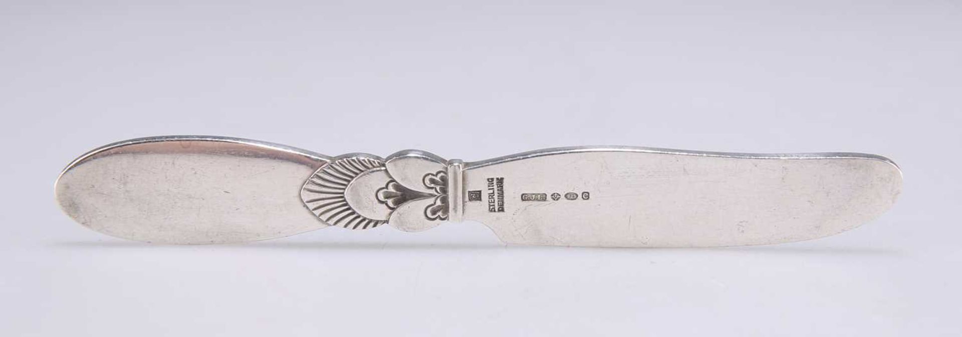 GEORG JENSEN: A DANISH STERLING SILVER CACTUS PATTERN BUTTER KNIFE