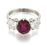 A PLATINUM RUBY AND DIAMOND THREE STONE RING