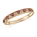 AN EARLY 20TH CENTURY 9 CARAT GOLD GARNET AND DIAMOND BANGLE