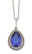 AN 18 CARAT WHITE GOLD TANZANITE AND DIAMOND CLUSTER PENDANT ON A PLATINUM CHAIN