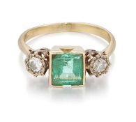 AN EMERALD AND DIAMOND THREE STONE RING