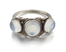AN ARTS AND CRAFTS MOONSTONE THREE STONE RING