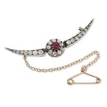 A LATE 19TH / EARLY 20TH CENTURY RUBY AND DIAMOND CRESCENT CLUSTER BROOCH