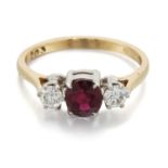 AN 18 CARAT GOLD RUBY AND DIAMOND THREE STONE RING