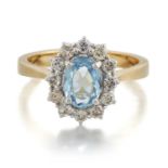 AN 18 CARAT GOLD AQUAMARINE AND DIAMOND CLUSTER RING