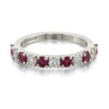 A PLATINUM RUBY AND DIAMOND HALF HOOP RING