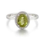 A PLATINUM PERIDOT AND DIAMOND CLUSTER RING