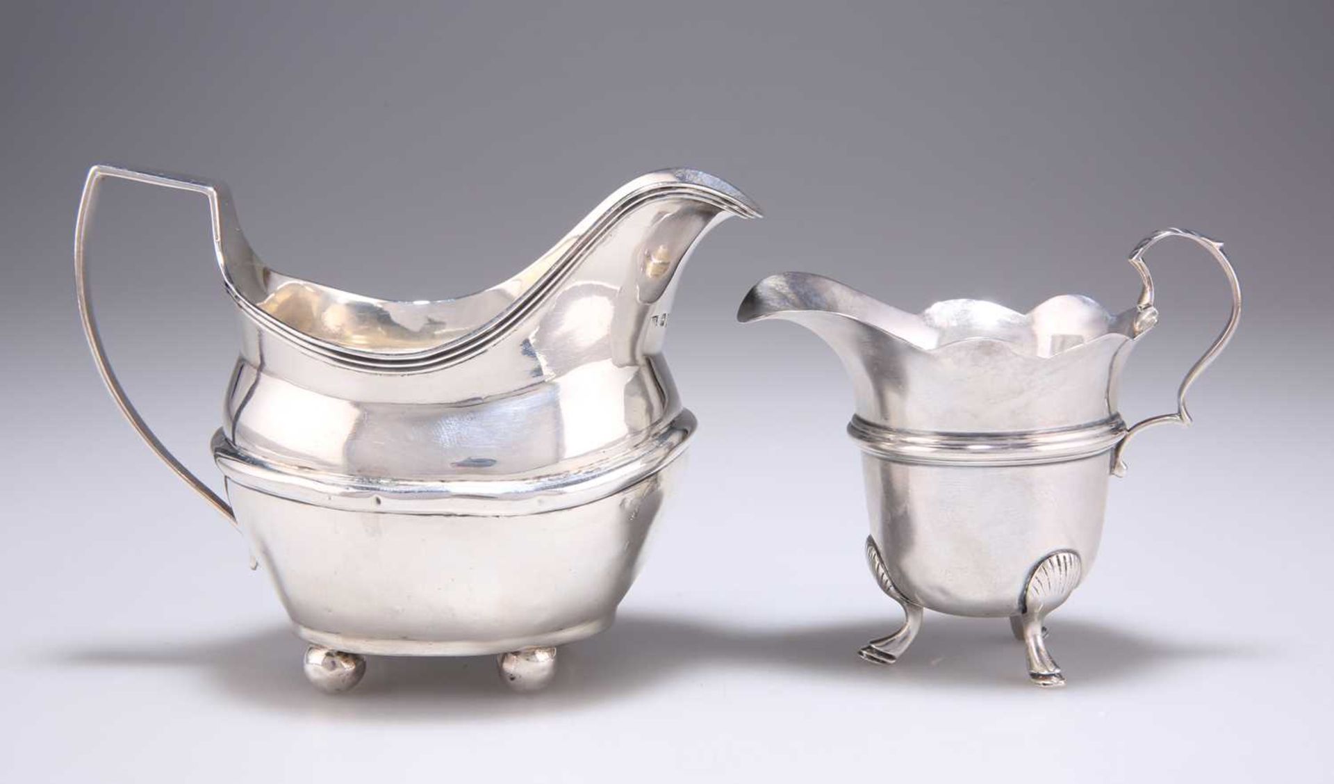 A GEORGE III SILVER CREAM JUG, AND AN EDWARDIAN SILVER CREAM JUG