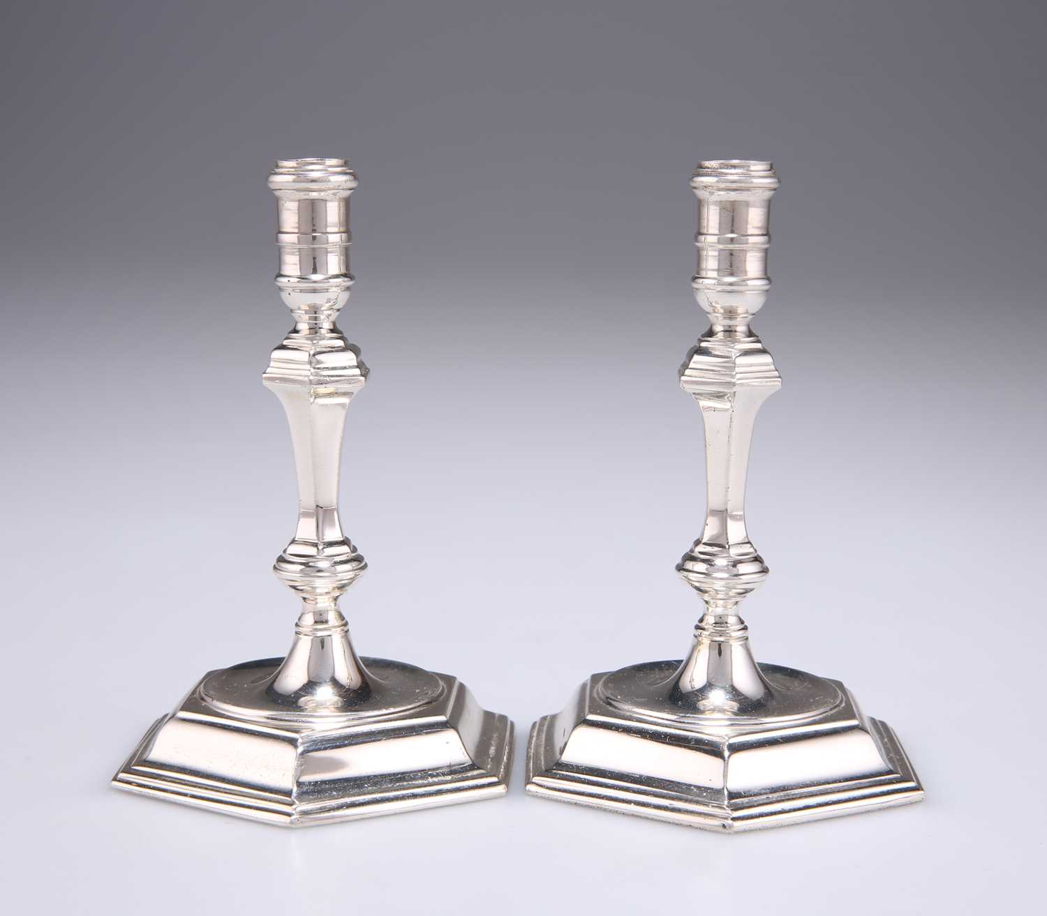 A PAIR OF ELIZABETH II CAST SILVER TAPER STICKS