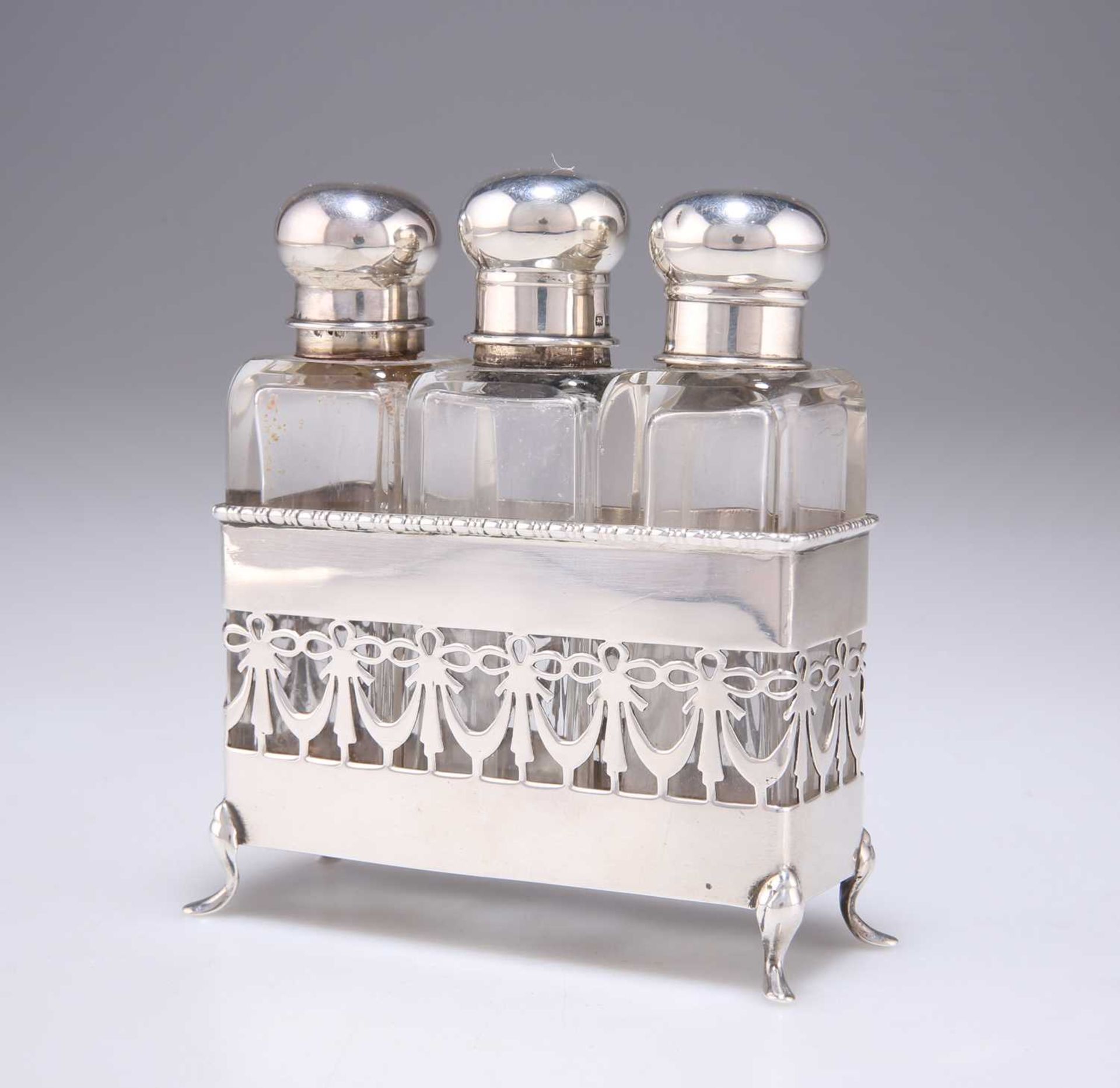 A GEORGE V SILVER SET OF THREE SILVER-TOPPED GLASS SCENT BOTTLES IN A SILVER STAND - Image 2 of 3