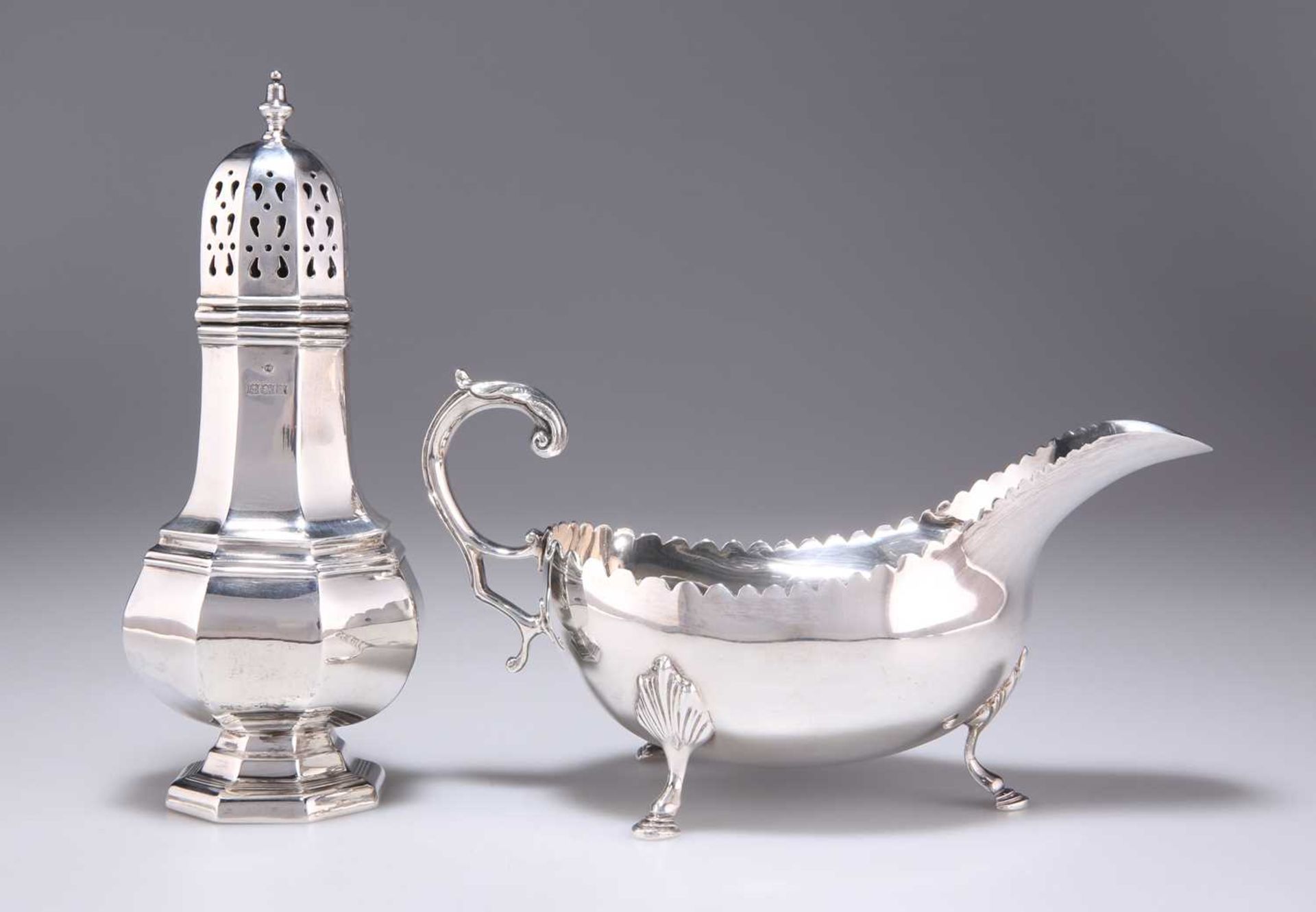 AN ELIZABETH II SILVER SUGAR CASTER, AND AN IRISH SILVER SAUCEBOAT