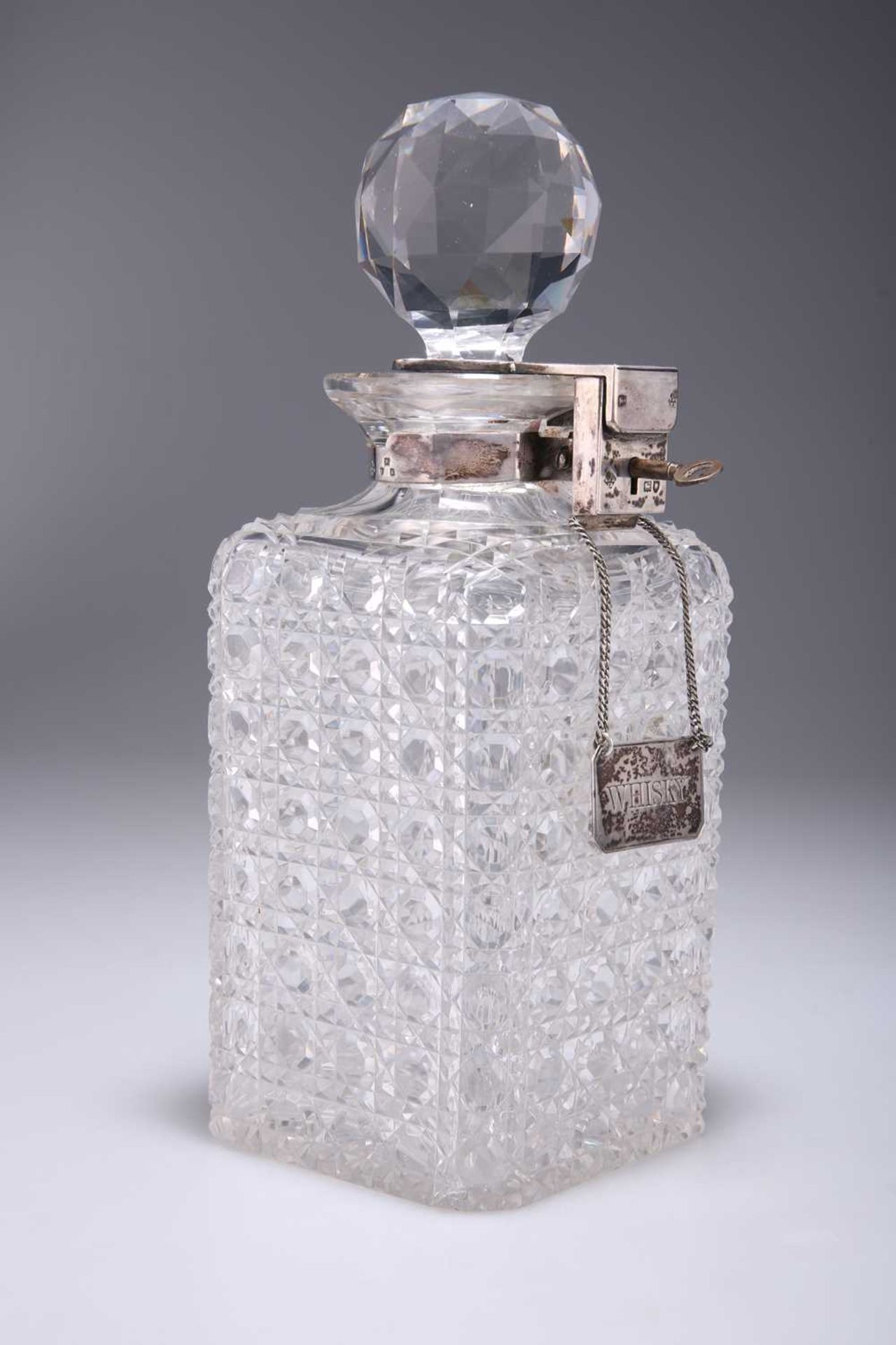 A VICTORIAN BETJEMANN'S PATENT SILVER-MOUNTED CUT-GLASS LOCKING DECANTER