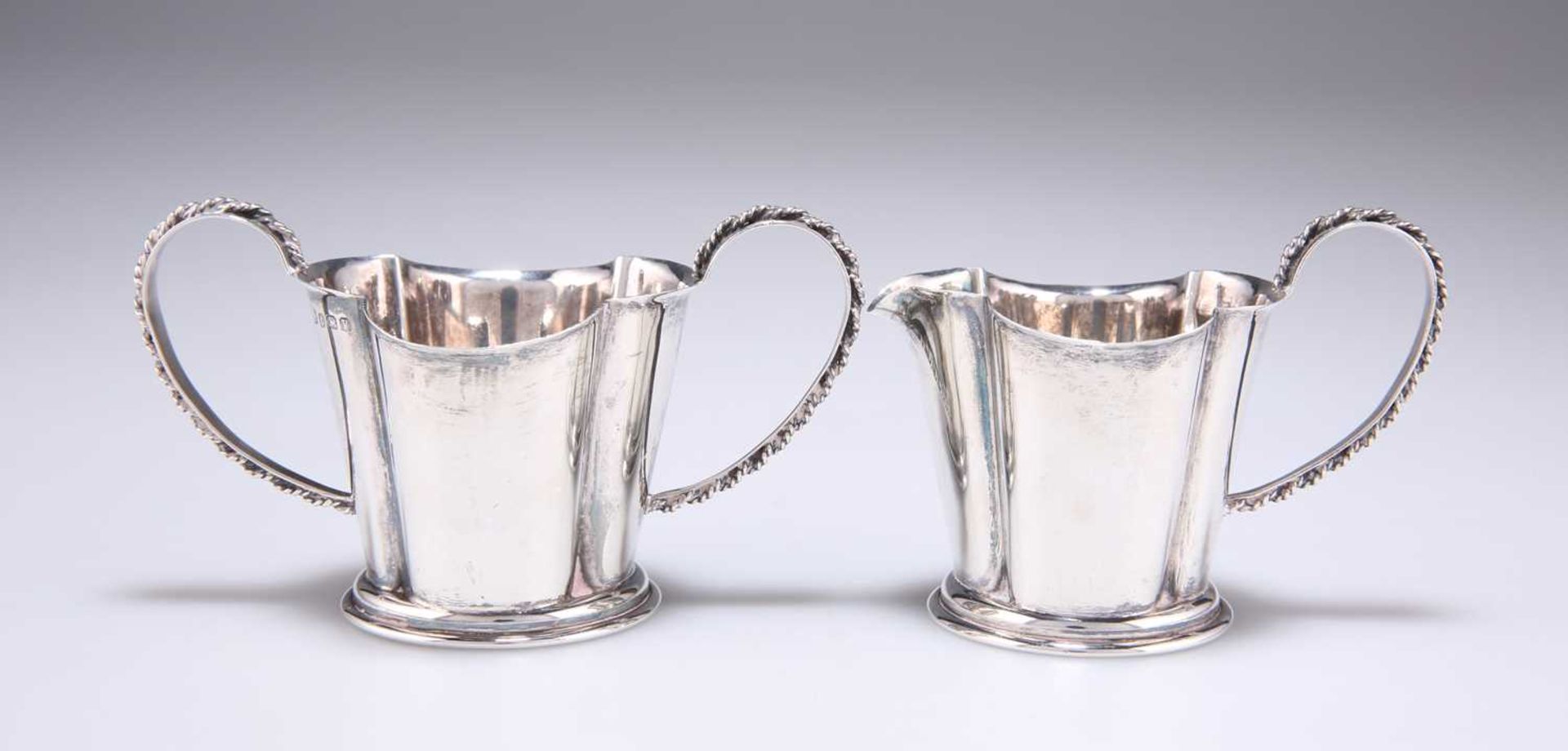 A GEORGE V SILVER TWO-HANDLED SUGAR BOWL AND CREAM JUG