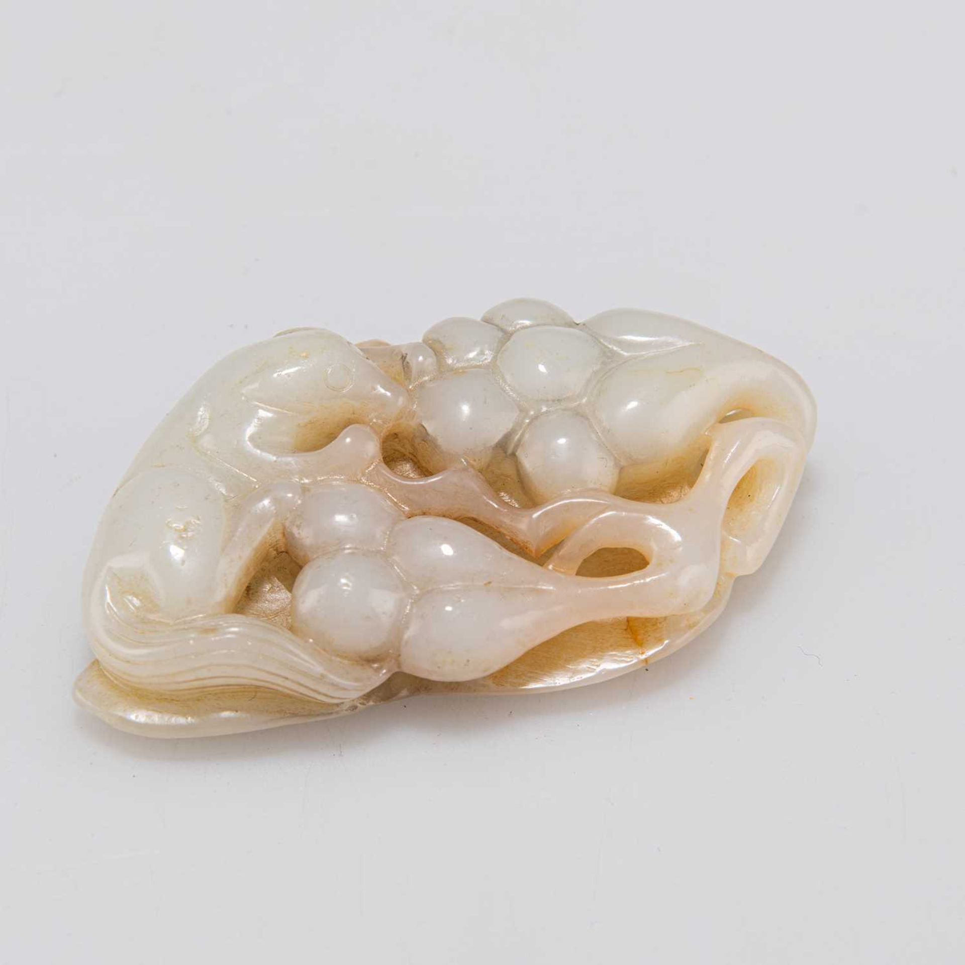 A CHINESE JADE GROUP OF A SQUIRREL AND GRAPEVINE