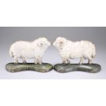 A PAIR OF VICTORIAN PAINTED CAST IRON SHEEP DOOR STOPS