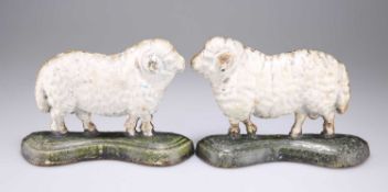 A PAIR OF VICTORIAN PAINTED CAST IRON SHEEP DOOR STOPS