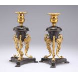 A PAIR OF REGENCY PATINATED AND GILT BRONZE DWARF CANDLESTICKS, IN THE MANNER OF CHENEY, LONDON